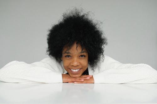 woman in white sweater smiling