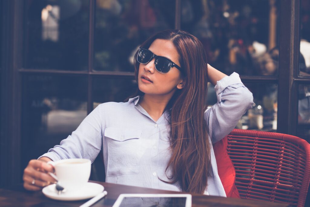 woman drinking tea at an outside cafe