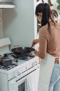 woman cooking in wok