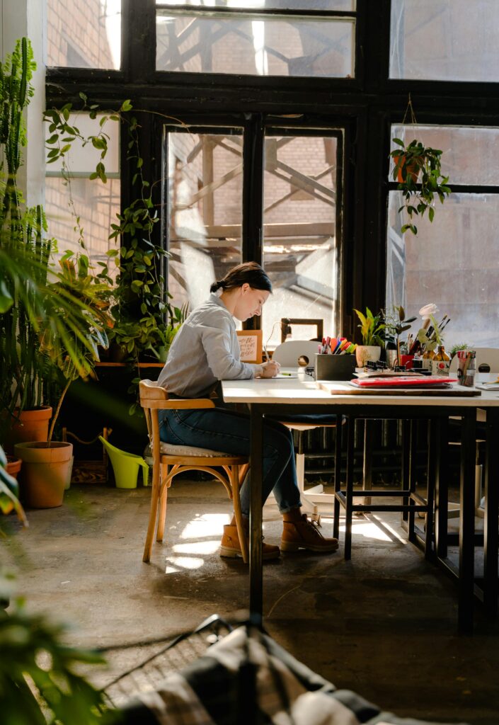 woman at desk creating