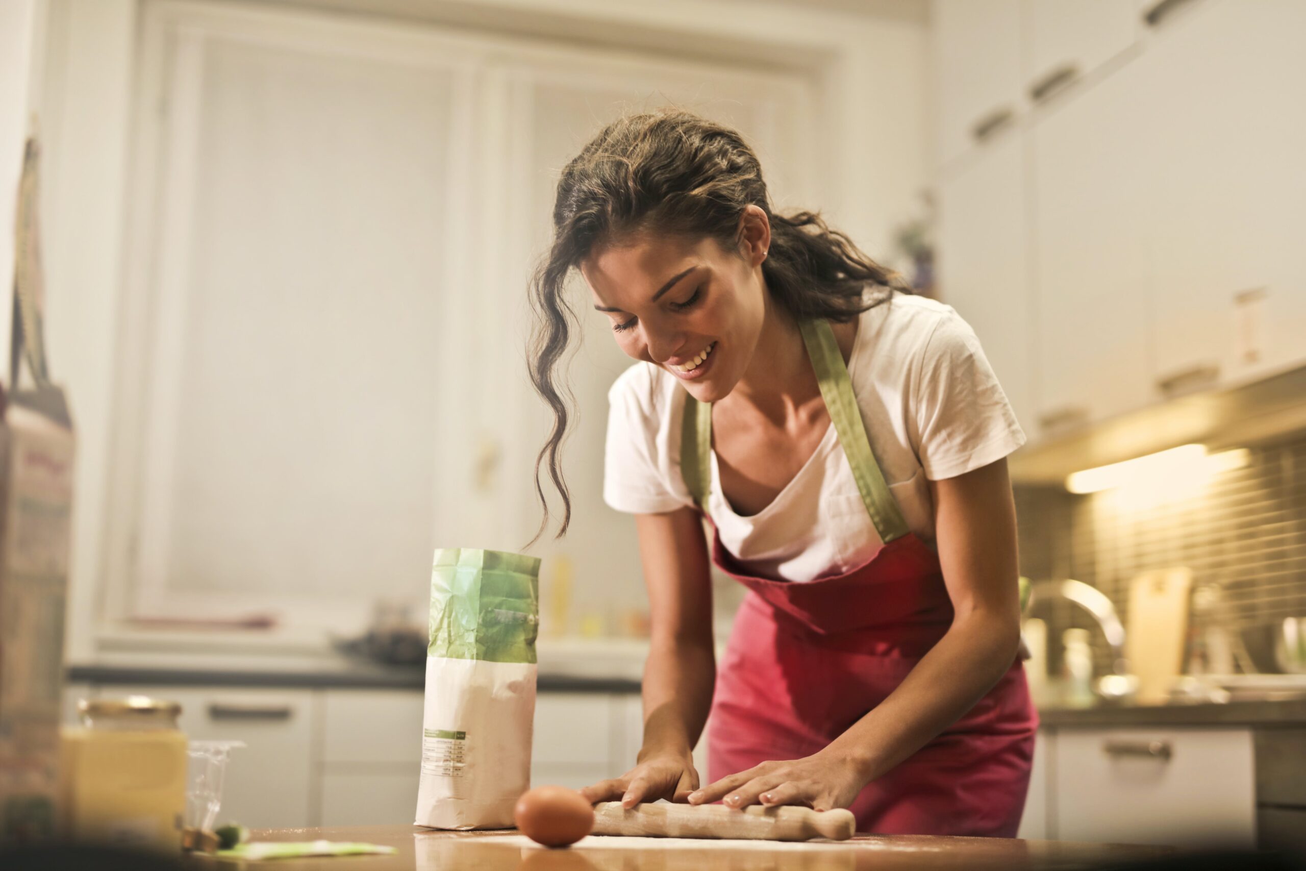 woman cooking in a kitchen practicing one of 7 Free Steps Toward Wellness