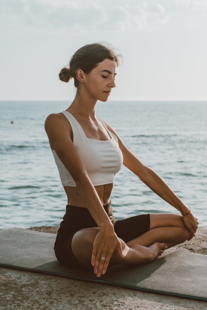 woman on yaga mat near water