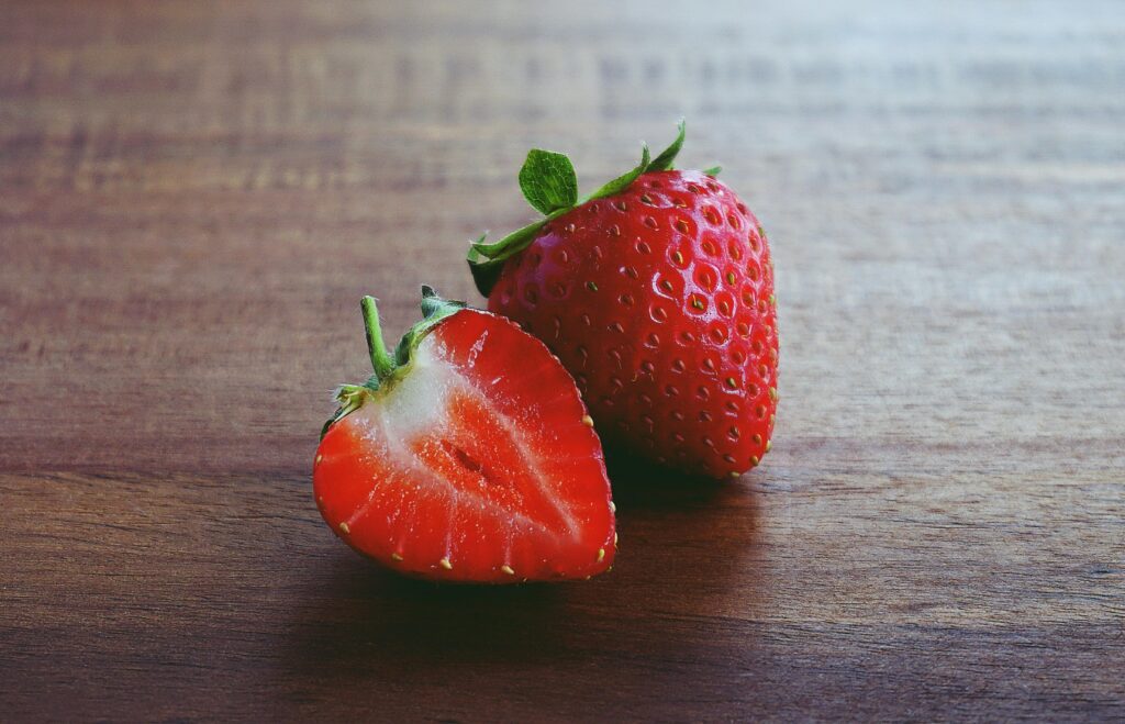 two strawberrys on board for a Detoxifying Fruit Salad