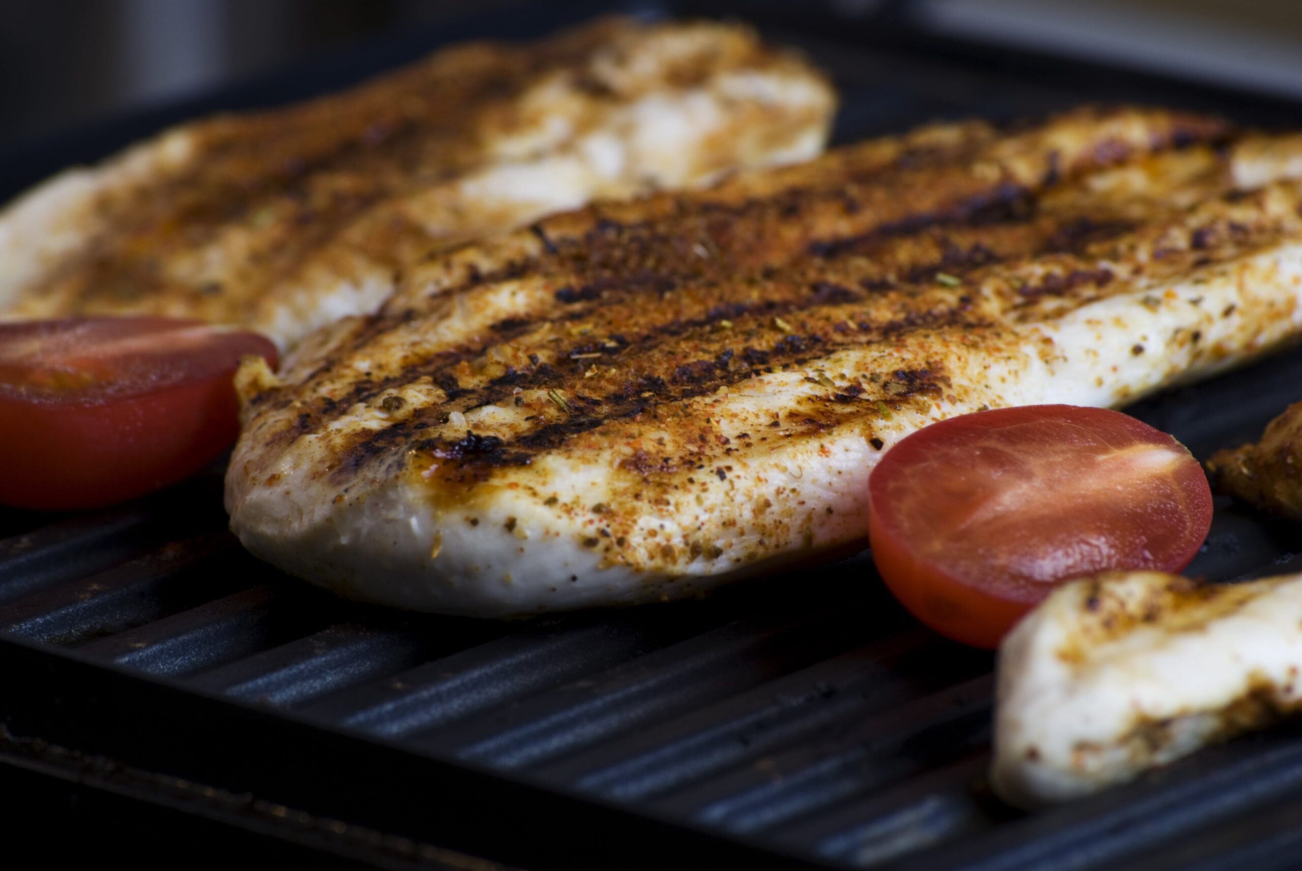 Chicken on a grill for a Grilled Chicken and Quinoa Salad with Lemon Vinaigrette