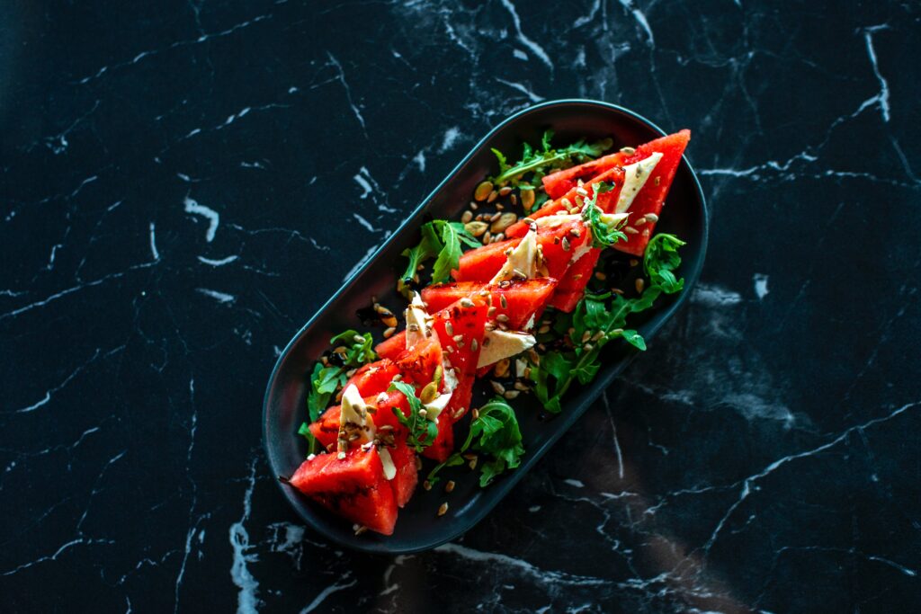 watermellon and mint salad on black plate