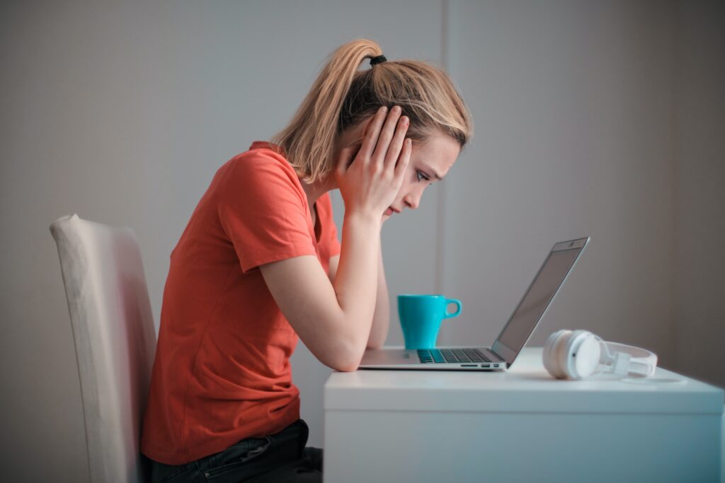 woman anxiously looking at computer