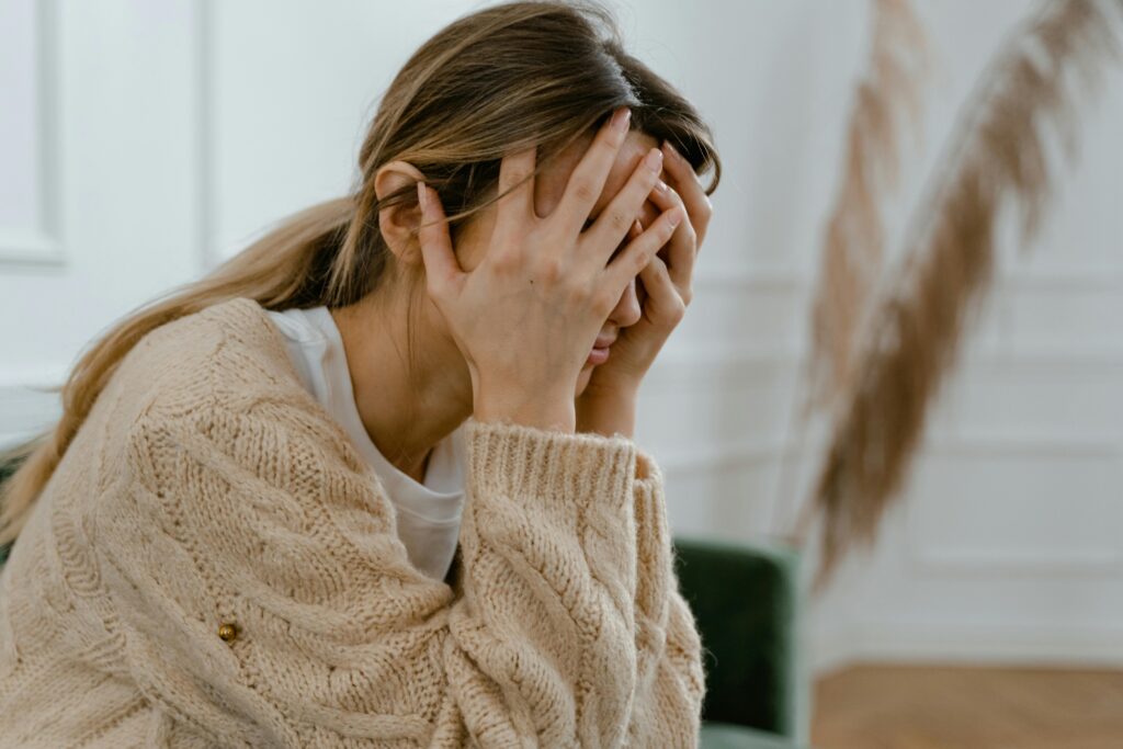 Frustrated woman with face in her hands for 5 Key Gene Mutations That May Be Affecting Your Mental Health post