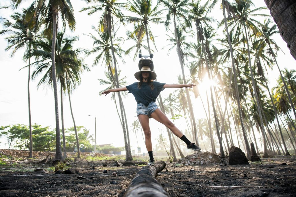 Woman balancing on a log in nature for Balancing Your Nervous System: Tips for Natural Wellness post